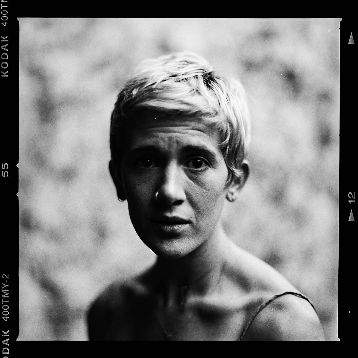 kodak t-max 400 portrait in an outdoor studio of sad girl on black and white film